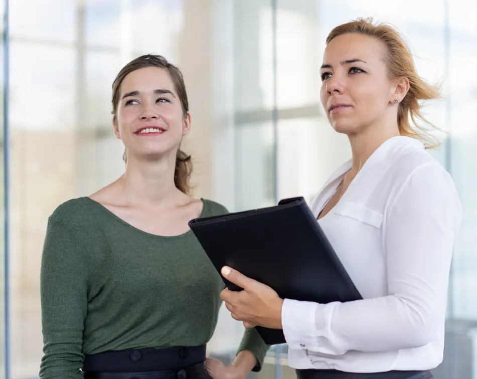 Two women consulting together