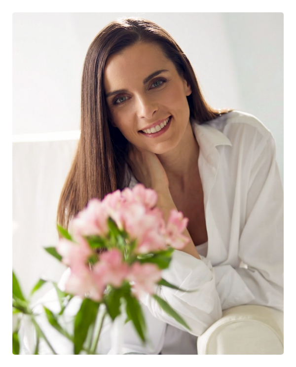 Woman smiling during ongoing hormonal care monitoring